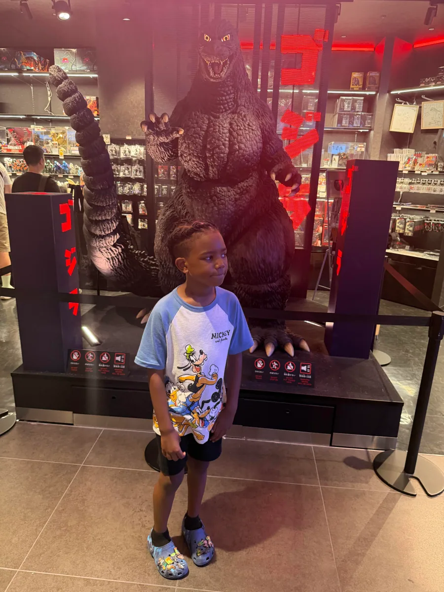 Cruz beside a red-lit monster display