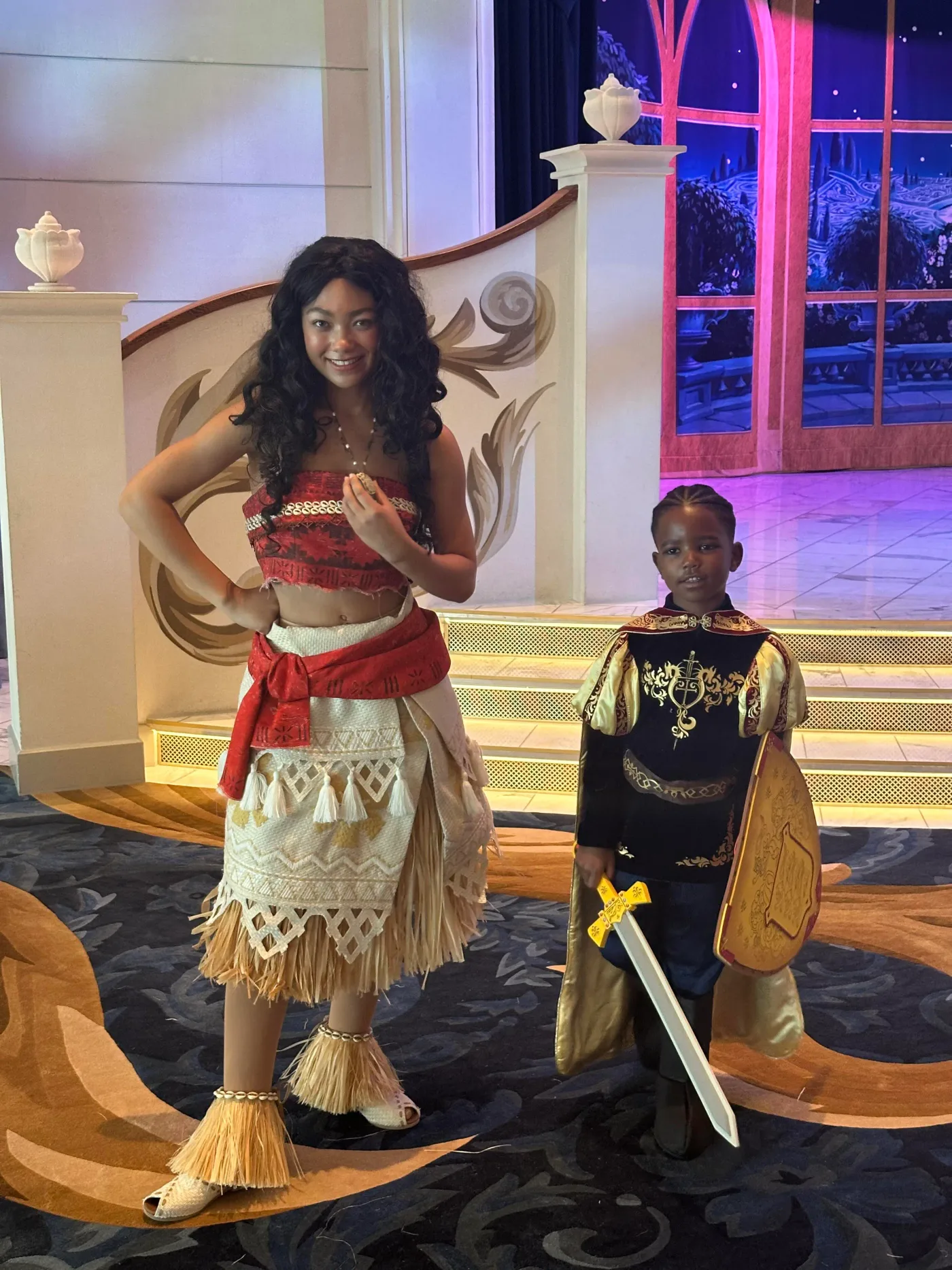 Two children in costume on a cruise ship deck